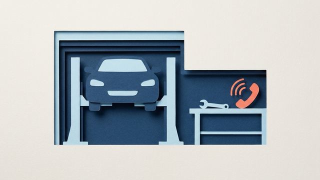 Бумажный автомобиль на подъёмнике в гараже, на верстаке гаечный ключ и коралловая телефонная трубка